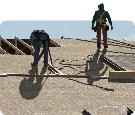 Roofing crew working on a flat commercial roof deck