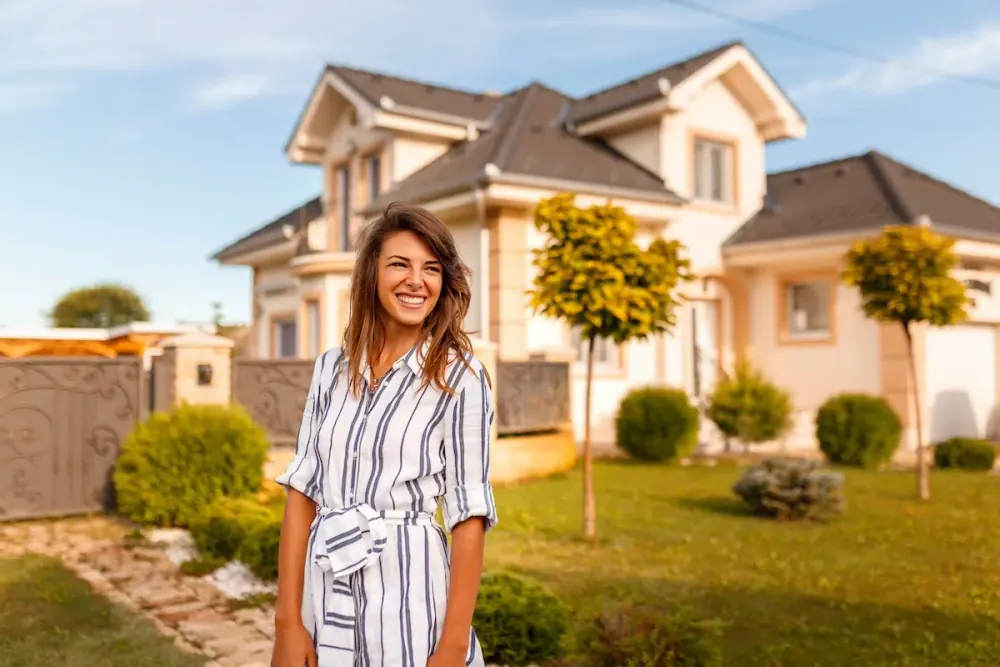 Homeowner standing in front of her house with a new roof