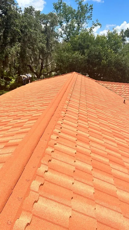 Orange barrel tile roof under a bright sky