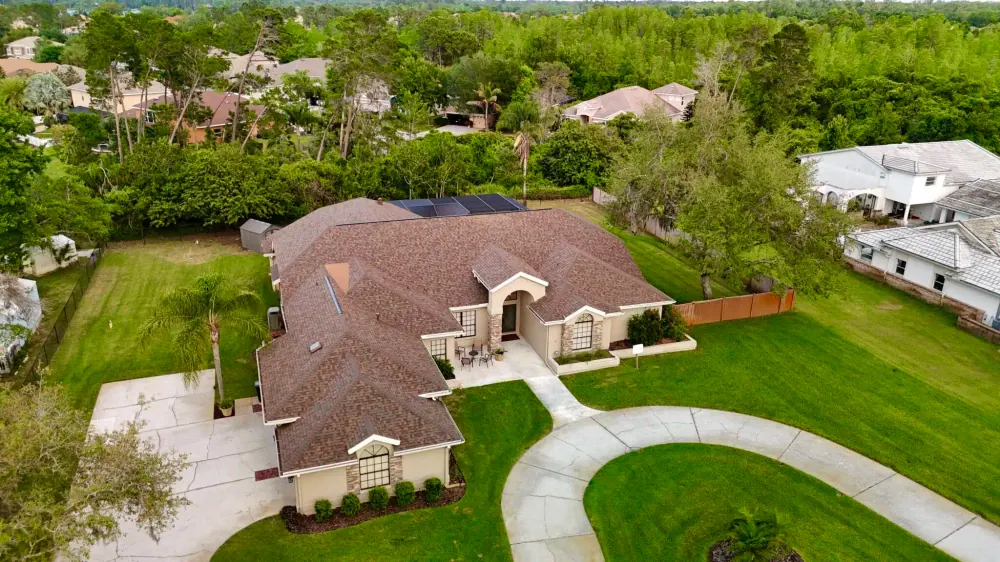 Aerial view of a single-family home with a new shingle roof in Riverview, FL