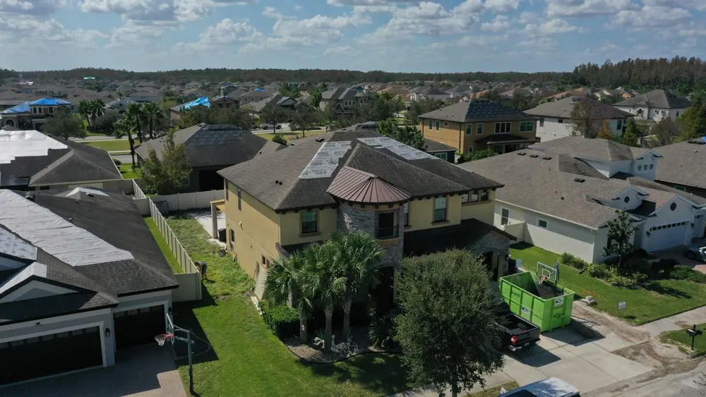 Aerial view of a two-story home with a new shingle roof in St. Petersburg, FL