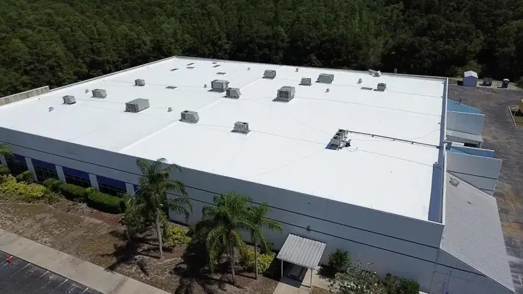 Aerial view of a white TPO roof on a commercial building